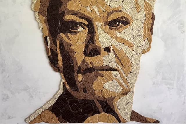 The handcrafted portraits took over 180 hours to complete using over 1,000 biscuits
