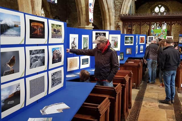 Visitors browse the photographs on display at West Haddon Photo Club's Photo Show.