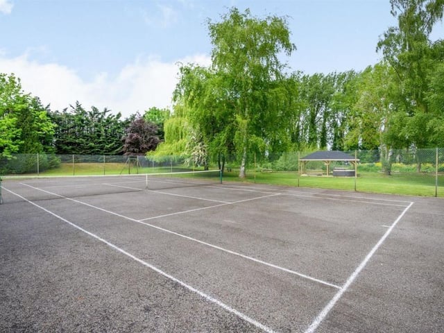 This Victorian home has a tennis court, huge gardens and a private mooring on the River Nene.