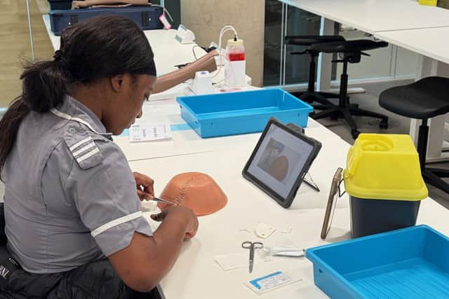 A Midwifery student practices stitches/suturing.