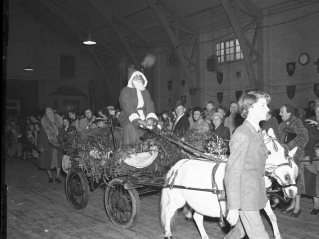 Santa arriving at a Christmas event on a pony cart