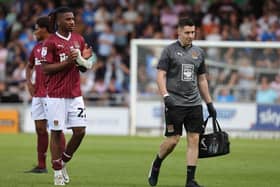 Akin Odimayo of Northampton Town walks from the pitch with physio Michael Bolger after receiving treatment Saturday's League One match at Sixfields. (Photo by Pete Norton/Getty Images)
