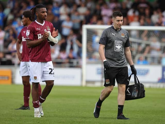 Akin Odimayo of Northampton Town walks from the pitch with physio Michael Bolger after receiving treatment Saturday's League One match at Sixfields. (Photo by Pete Norton/Getty Images)