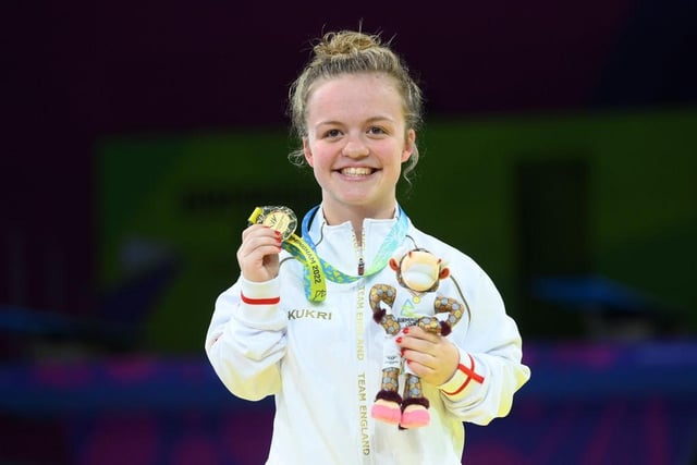 Maisie Summers-Newton of Team England shows her delight as she shows off her gold medal
