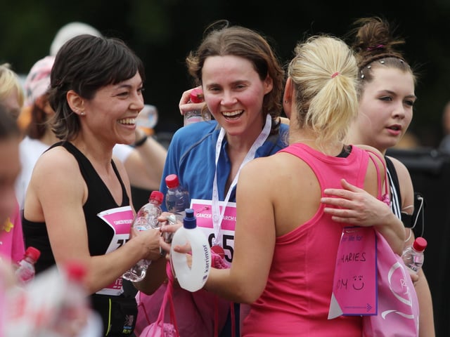 2011 - Runners congratulate each other after finishing the 5k Race for Life at Abington Park in Northampton.