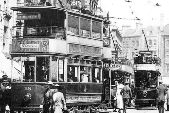 Trams going through the Drapery. Pre 1930s.