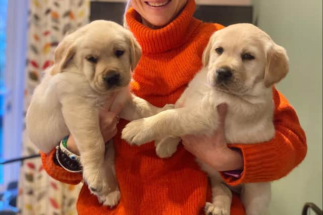 Dog Breeding volunteer Lucy with two of Hobnob's litter