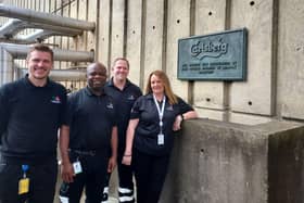 Head of quality Tom Spencer, head brewer John Njoku, head of packaging Tim van Heusden and director of brewing Emma Gilleland in front of the 1974 inauguration plaque at Carlsberg Northampton.