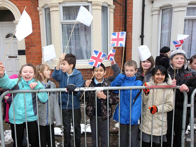 Chldren wait patiently for the Prince to pass by outside Crockett and Jones shoe factory in Perry Street