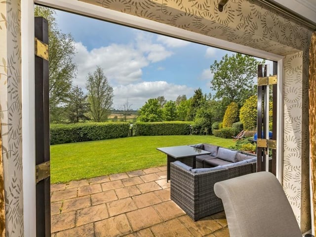 French doors lead out to the patio area and substantial back gardens, with views of the adjoining golf course and lake