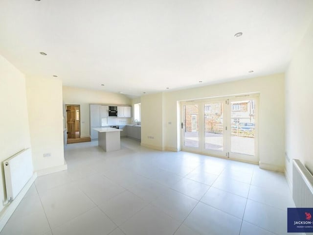 The open plan ground floor leads from the kitchen to the lounge