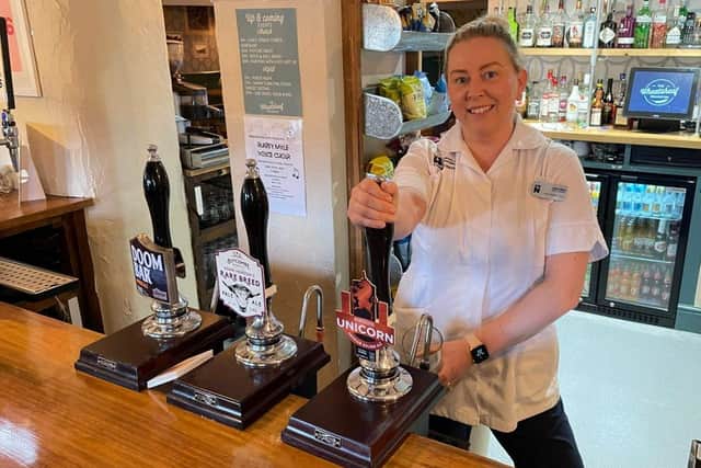 Claire Eyles behind the bar of The Wheatsheaf.