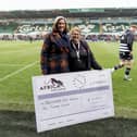 Northampton Saints Foundation’s Fundraising Officer, Sue Wright, receives a cheque from Laura Burdett-Munns, Chief Executive of Africa Exclusive.