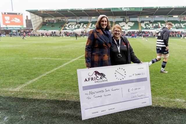 Northampton Saints Foundation’s Fundraising Officer, Sue Wright, receives a cheque from Laura Burdett-Munns, Chief Executive of Africa Exclusive.