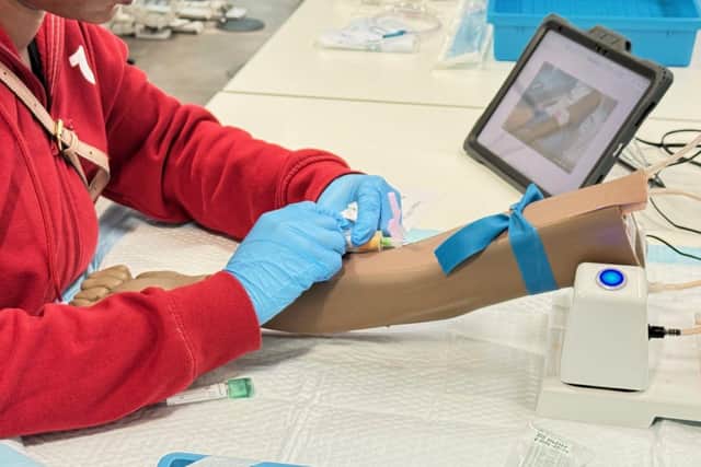 Practicing taking a blood sample.