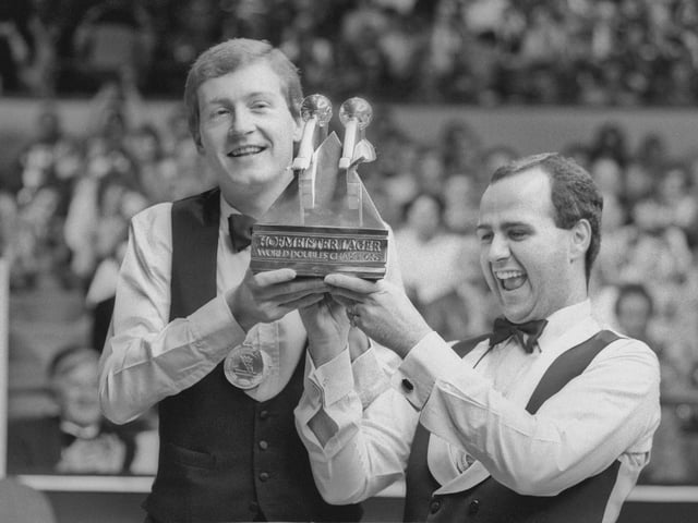 Steve Davis (left) and Tony Meo with the trophy after winning the snooker World Doubles Championship at the Derngate Centre, Northampton, 14th December 1987. (Photo by Frank Tewkesbury/Daily Express/Hulton Archive/Getty Images)