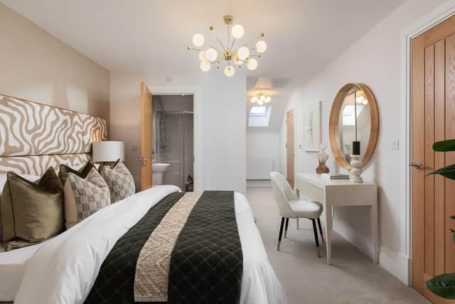 The statement of the home is a top-floor primary suite, showcasing a vaulted ceiling, dedicated dressing area, and private en-suite.