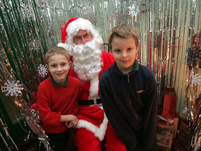 Spring Lane Primary school Christmas fundraising night. Pictured are, left to right, Joe Prickett (10), Santa and Jamie Hobbs (8)