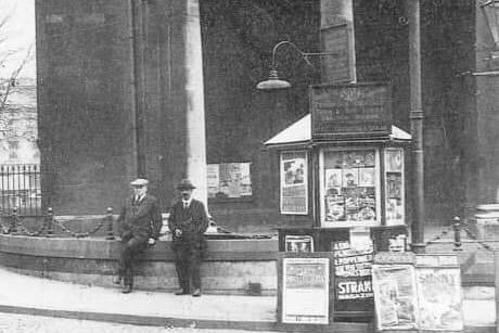 Two men standing outside All Saints Church. Circa 1950s.