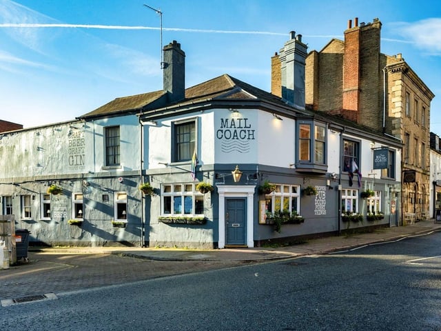 According to estate agents, this is a rare chance to take on one of Northampton’s best-known pubs. Prominently located in the town centre, The Mailcoach is described as a top performer on the local circuit, known for its drinks, food, and lively atmosphere. The venue features an 80-cover open-plan trading area with booth seating, a large bar servery, and a fully equipped kitchen servicing both in-house and dark kitchen operations. With a strong reputation for live sport, music, and community events, it also includes two pool tables and a quirky courtyard with 50 covers. Popular with locals, theatre-goers, and students alike. The venue boasts a forecast annual turnover of £815,605, with £693,256 from wet sales and £122,348 from food. The guide rent is set at £65,000 per year, with a turnover rent of £28,722 per annum.
