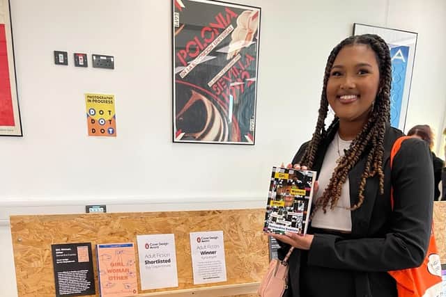 Karla holding her winning book cover at the University of Northampton's Degree Show.