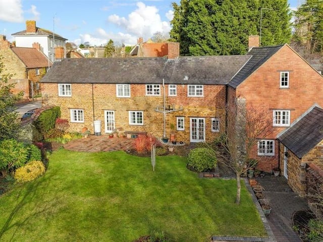 Three doors lead out to the lush and spacious back garden, surrounded by a stone wall for privacy