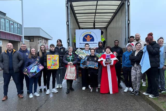 Mother Christmas collects the gifts donated to the annual gift appeal by Northampton Town FC/ Mother Christmas
