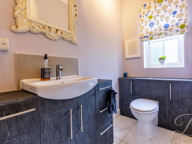 Completing our photos of the ground floor at New Park Lane is this attractive toilet. It comprises not only a low-flush WC but also a hand wash basin and storage.
