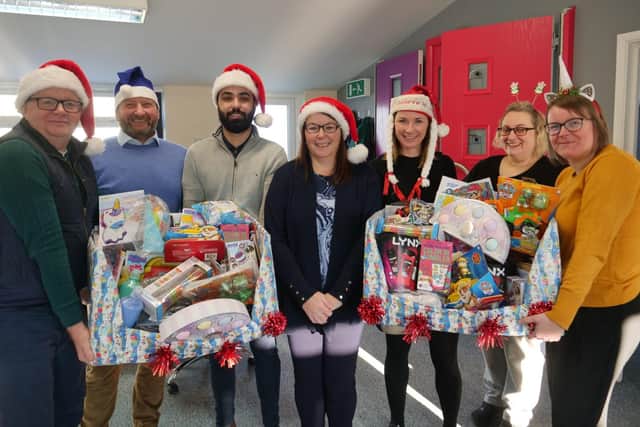 Pictured preparing presents for delivery to children spending Christmas at Northampton General Hospital and Kettering General Hospital are the team at Matthew Oliver Windows & Doors. 