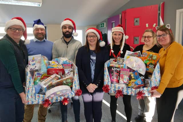 Pictured preparing presents for delivery to children spending Christmas at Northampton General Hospital and Kettering General Hospital are the team at Matthew Oliver Windows & Doors.