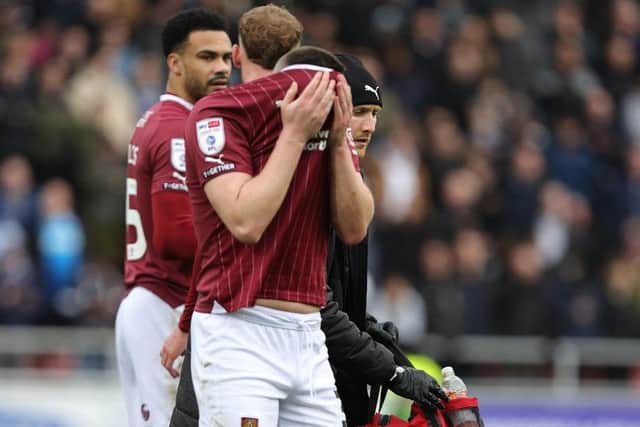 A disconsolate makes his way off after picking up an injury against Bolton
