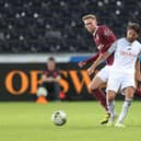 Joe Allen attempts to control the ball under pressure from Mitch Pinnock during the Carabao Cup first round match between Swansea City and Northampton Town at Swansea.com Stadium. (Photo by Pete Norton/Getty Images)