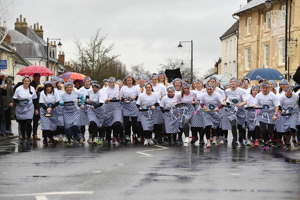 Video and pictures: Rain could not dampen the spirits of famous Olney Pancake Race in Milton Keynes 