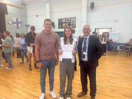 Staff celebrating students’ results. Mr Cope (left), Emily (centre) and Mr Frazer (right).