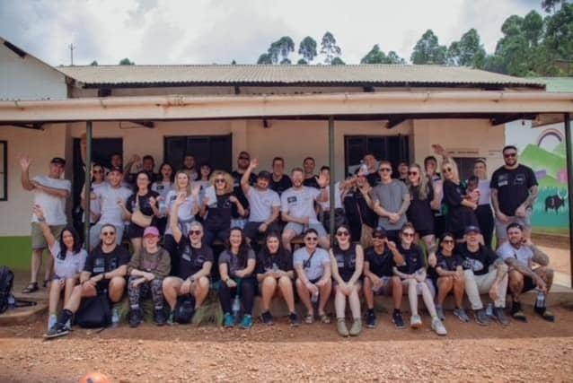 The volunteers who took part in the trip with The Abode Project to Uganda outside The Abode Junior School.