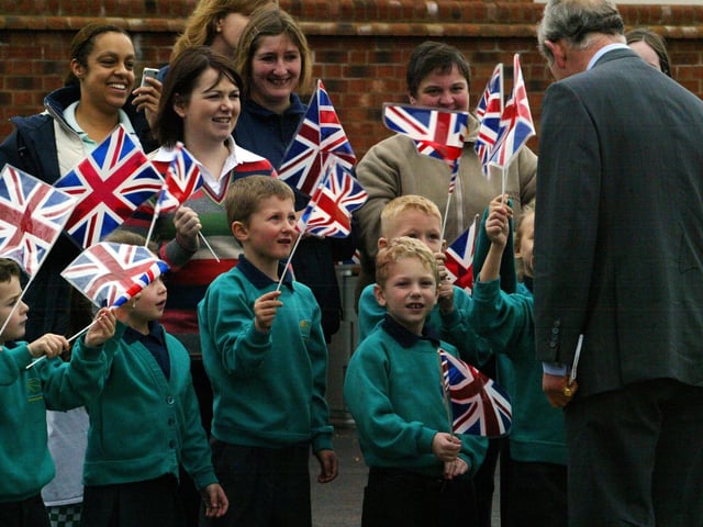 Prince Charles speaks with children at Upton Meadows Primary School