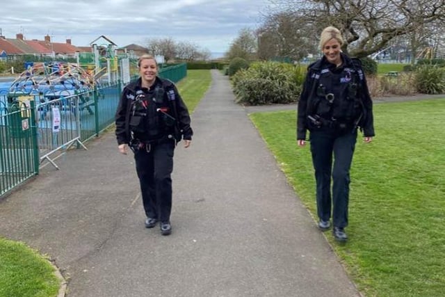 Two officers pass an empty playground