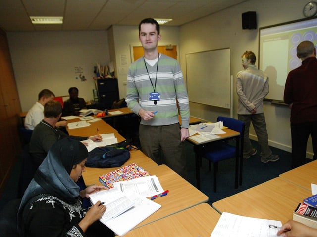Teacher / Tutor Jon McGowan teaching students on the white board at Northampton College