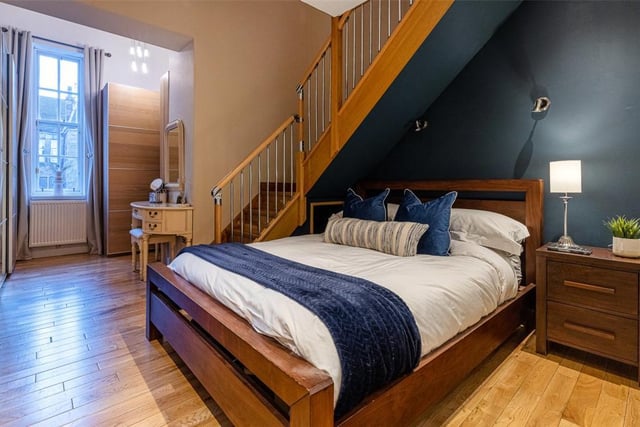 The master bedroom has a built-in wardrobe, en-suite and stairs to a study area.