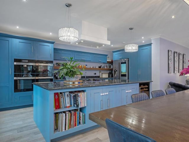 Here is the vibrant blue open plan kitchen-diner and family room.