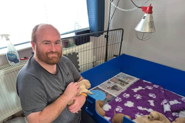 Breeding Dog Volunteer Rob Chivers with guide dog mum Fiji's litter.