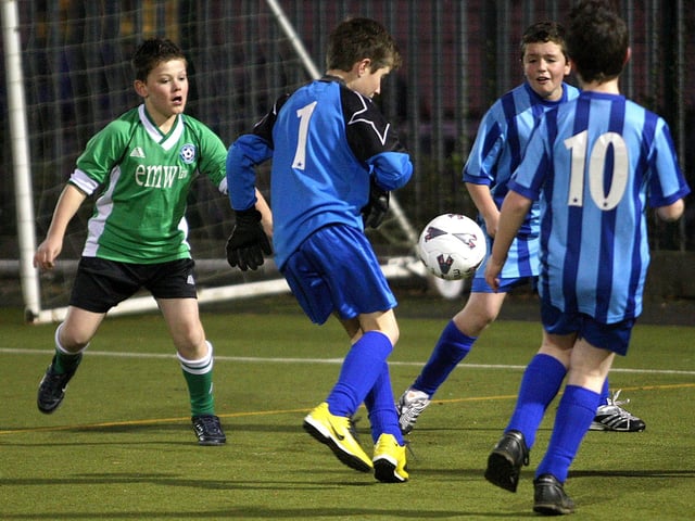 A football tournament at Unity College, organised by Northampton School Sports Partnership. Football action from St Luke's Primary School (green), V Hunsbury Park Primary School (blue).