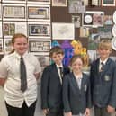 Pupils with some of their artwork on display at the London exhibition