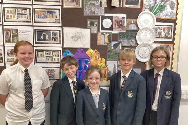 Pupils with some of their artwork on display at the London exhibition