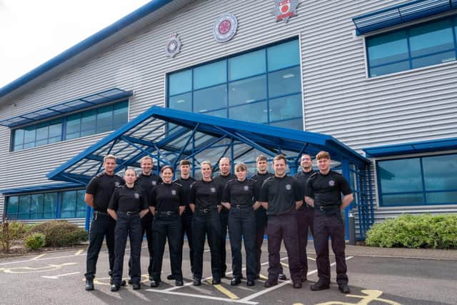 Twelve new firefighters stood outside NFRS HQ