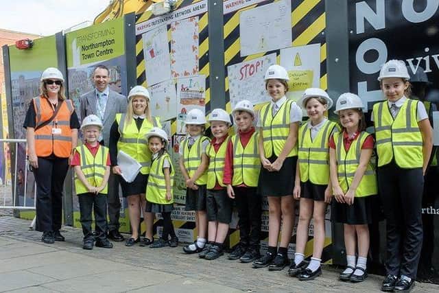 Children from Hunsbury Park School standing outside the market square redevelopment