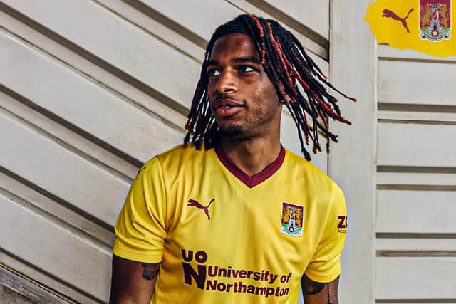 Defender Akin Odimayo models the new Cobblers away shirt for the 2024/25 season