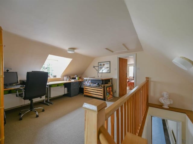 A converted loft includes space for an office, leading to one of the property's five bedrooms