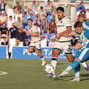 Sam Hoskins takes aim, watched closely by Massimo Luongo