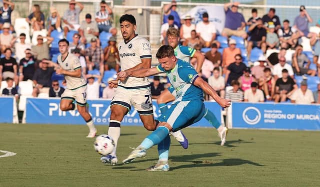 Sam Hoskins takes aim, watched closely by Massimo Luongo